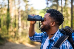 man using binoculars