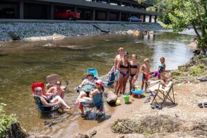 family by river at camp riverslanding